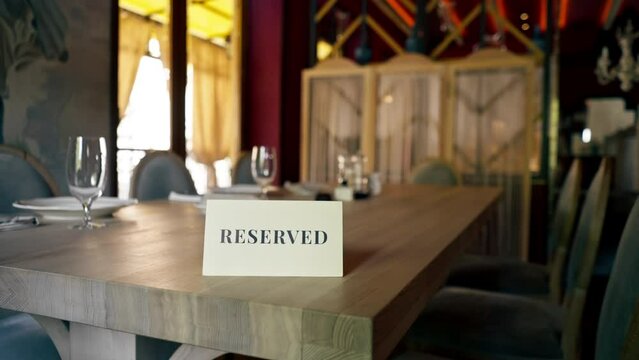 close-up of a reservation sign reserved  standing on a table in an expensive luxury Italian restaurant
