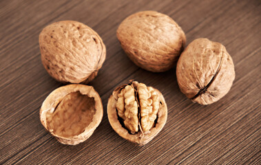 Kernels, shells and whole walnuts on a dark table. Healthy Eating.
