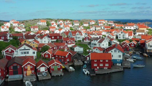 Flying over rooftops of fishing village. A typical village in Sweden by seacoast