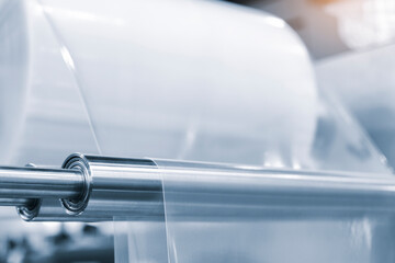 Automatic polyethylene plastic bag production machine with lighting effect. Close-up of the roller...