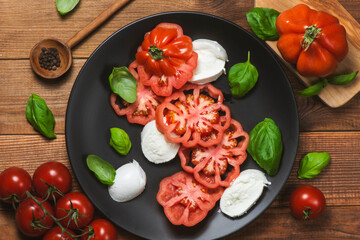 Tomato salad with mozzarella cheese and basil leaves