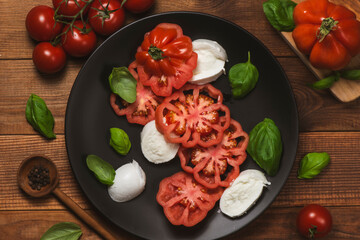 Tomato salad with mozzarella cheese and basil leaves