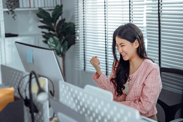 Yes! Happy excited successful asian businesswoman triumphing in office, Female freelance entrepreneurs receive good news online.