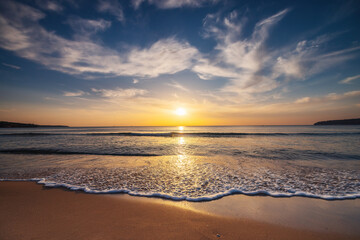 Fototapeta na wymiar Beautiful cloudscape over the sea waves and sand, beautiful tropical beach sunrise