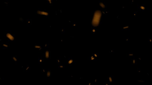 Huge falling VFX dust particles are isolated on a black background for composition.