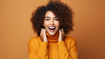 A joyful, beaming female adorned with cosmetics gleefully chuckling and signaling at the lens on an orange backdrop.