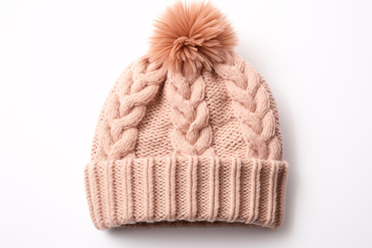 A beige knitted cap with a pom-pom featured on a white backdrop.