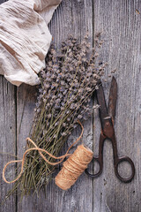 dry lavender flowers, old rusty scissors on wooden background