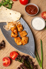 chicken kebab in a gray ceramic plate top view