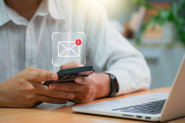 Businessman using email on smartphone with notification alerts for business email online communication and digital marketing. Email notifications in your inbox