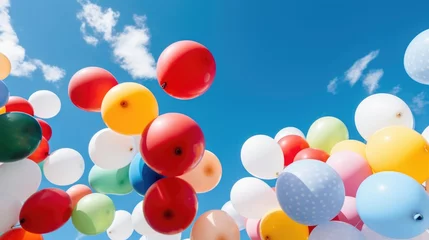 Fototapeten A bunch of balloons floating in the air © Friedbert