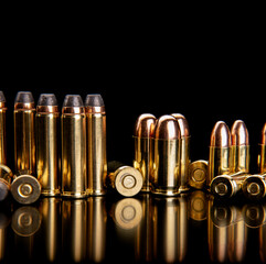 Bullet isolated on black background with reflexion. Cartridges for rifle and carbine on a black....