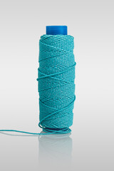 ball of thread, spool of sewing thread and needle isolated on white background