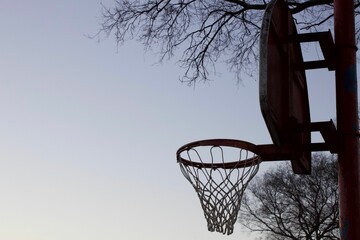 Basketball hoop with a backboard against a blue sky