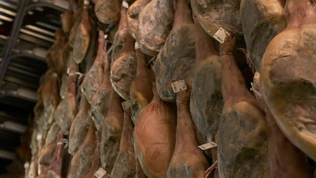Jamon serrano pig legs factory hanging in a industry. Iberian ham elaboration process