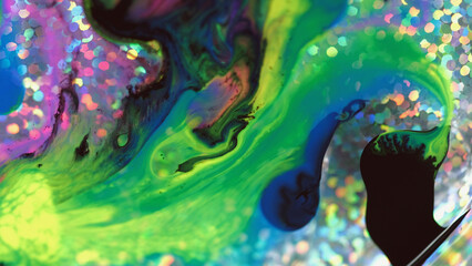 Fluid art texture. Paint water flow. Bright neon green pink black color wet ink mix motion on...