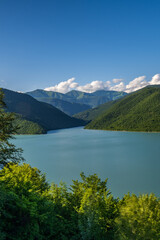 Fototapeta na wymiar Georgia's Zhinvali Reservoir: A Visual Symphony of Lakeside Splendor and Majestic Caucasus lake in the mountains