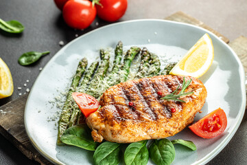 juicy chicken breast grilled with vegetables asparagus and parmesan, organic healthy products. Detox and clean diet concept. top view
