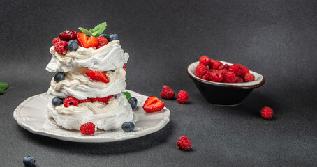 Obraz na płótnie Canvas Pavlova cake with berries with topping with whipped cream and strawberries. culinary, bakery, food concept