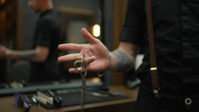 The hairdresser holds scissors for cutting hair