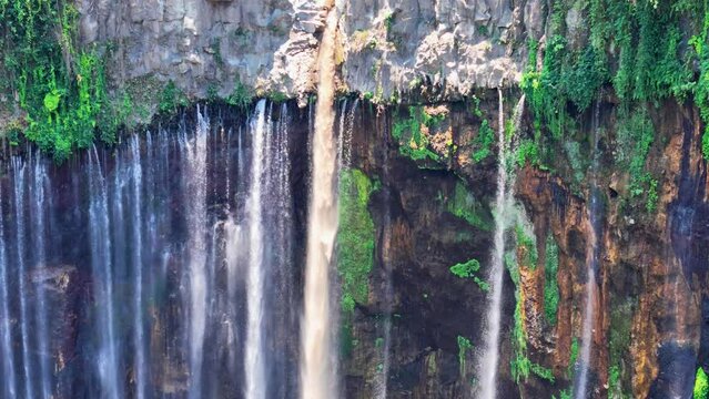 Aerial 4K close up footage of Tumpak Sewu also known as Coban Sewu waterfall. A jungle waterfall in East Java,  Indonesia