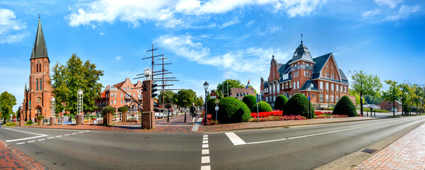 Panorama of Papenburg with town hall, church and ship on a sunny day in summer, Germany