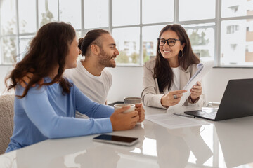 Happy Homebuyers. Spouses Having Consultation In Real Estate Agency