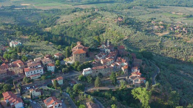 Sunset light over italian Tuscany hill top village and landscape olive growing