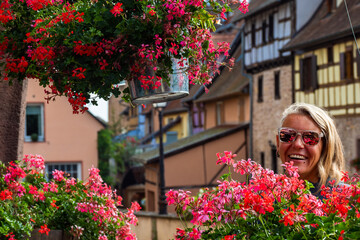Woman walking through the Beautiful Streets in the village Equisheim Alsace France