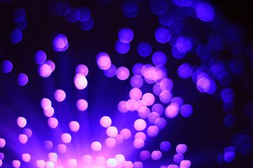 Abstract festive dark background with pink and blue bokeh lights