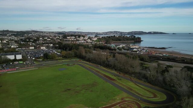 Paignton, Torbay, South Devon, England: DRONE VIEWS: A cyclo-cross event at Torbay VeloPark with Paignton skyline and Torbay coastline in background. Torbay is a popular UK holiday resort (Clip 1). 