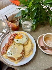 breakfast with eggs, bacon and coffee in a cafe