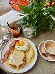 breakfast with eggs, bacon and coffee in a cafe