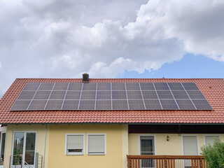 Solar photovoltaic panels on house roof. Modern country house with self-sustaining energy system