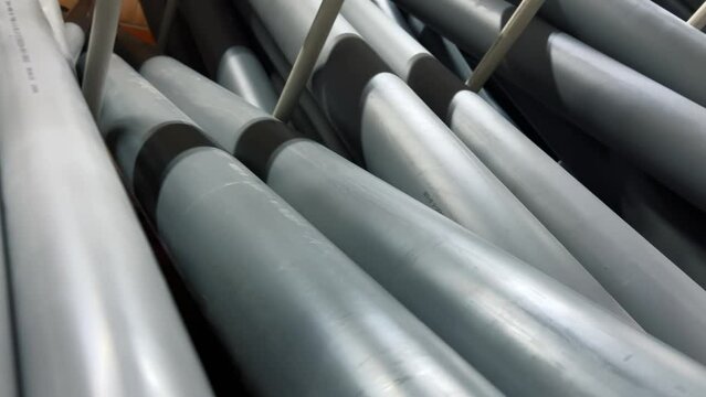 Plastic sewer pipes stacked in a hardware or plumbing store