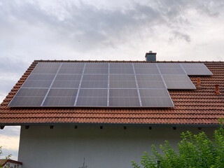 Solar photovoltaic panels on house roof. Modern country house with self-sustaining energy system