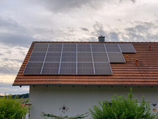 Solar photovoltaic panels on house roof. Modern country house with self-sustaining energy system