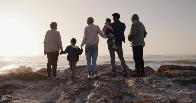 Big family, holding hands or children at beach for sunset to relax with grandparents on summer holiday. Dad, mom or back view of young kids bonding with grandmother or grandfather at sea together