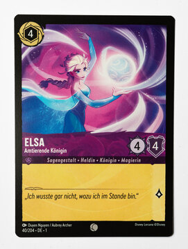 Hamburg, Germany - 10312023: macro photo of the German Ravensburger trading card Elsa Queen Regent from the Disney lorcana The first chapter set on white paper background.