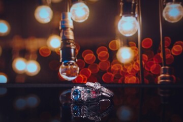 Closeup of wedding rings product with colorful bokeh background