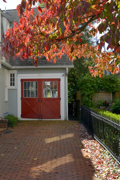 Historic house with barn door style red painted garage doors in Annapolis, MD