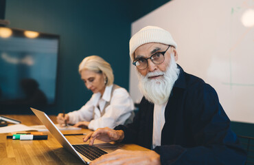 Mature man and woman working in office