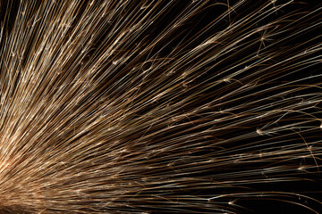 Obraz premium Rays of flying sparks on a dark background..