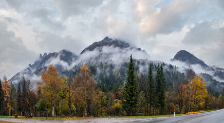 Cloudy and foggy autumn alpine mountain scene. Austrian Lienzer Dolomiten Alps.