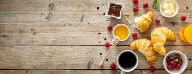 Continental breakfast with croissants, orange juice and cup of coffee on a wooden background with copy space top view - obrazy, fototapety, plakaty