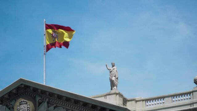 Spanish Flag waving on top of the Gobierno Militar de Barcelona on a sunny day