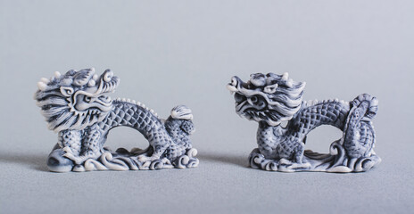 Two ceramic dragons on a gray background for Chinese New Year web banner