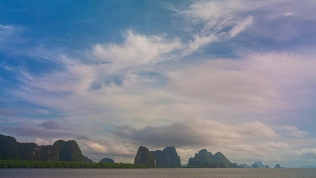 .Time lapse cloud above mangrove forest at Panyee island Phang Nga Thailand..beautiful sunrise above the ocean.scenery cloud moving over the islands..a village on the island far from civilization..