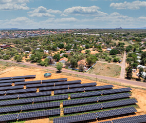 Aerial view, solar panels above crops ensuring fresh vegetables for the city situated near a busy...
