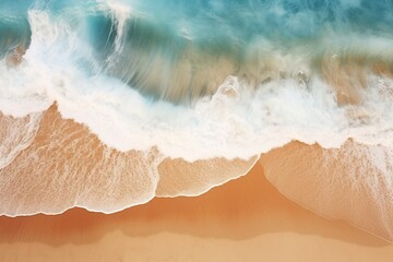 Aerial view of pristine beach waves creating rhythmic patterns on the sand
